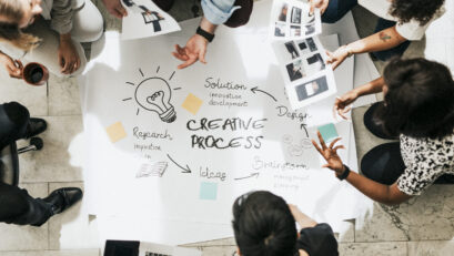 Business people brainstorming management process on paper