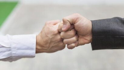 crop-men-bumping-fists