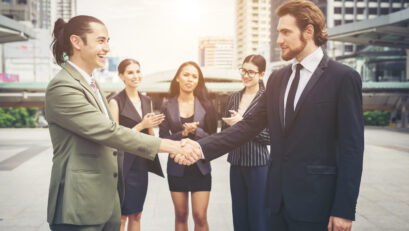 Happy business people shaking hands. Business success.