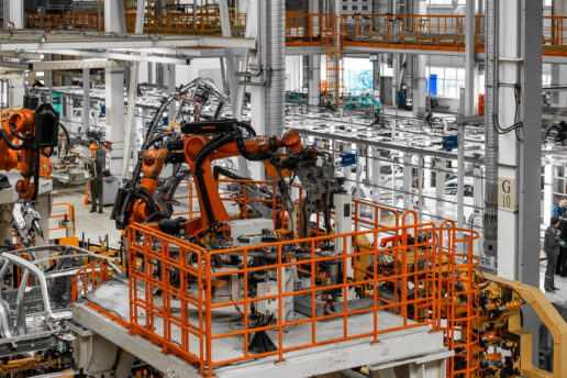 Photo of automobile production line. Welding car body. Modern car assembly plant. Auto industry. Interior of a high-tech factory, modern production.